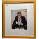 A signed colour photograph of Rod Stewart in yellow frame 26cm x 20cm complete with certificate of