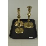 Three 18th Century brass candlesticks viz: one seamed with petal base 22cm high,