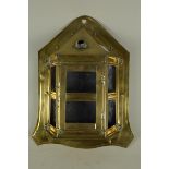 An early 19th Century brass wall candle lantern of half hexagonal form with shaped back plate,