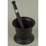 A heavy late 18th/early 19th Century cast iron pestle and mortar, 14cm high and 16 1/2cm dia,