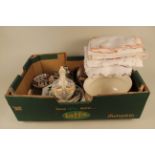 A mixed box including silver plated cutlery, lace and cotton tablecloths,