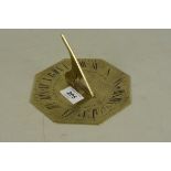 A brass sundial of octagonal form with engraved decoration and bearing date of 1760,