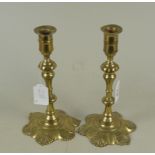 A pair of 18th Century seamed brass candlesticks with knopped baluster stems,