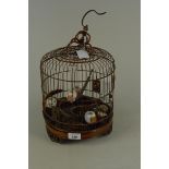 A modern Chinese ornamental bird cage of wire and carved wood construction and fitted with seven