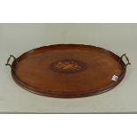 An Edwardian oval inlaid mahogany tray with twin brass handles