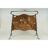 An Arts and Crafts wrought iron and copper fire screen with embossed sailing ship at sea decoration