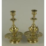 An fine pair of 19th Century aesthetic movement brass candlesticks, ornately cast with open work,