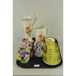 A Carlton ware cruet set plus three ceramic floral displays and two jugs