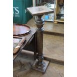 An oak plant stand with turned column and changeable base and plinth