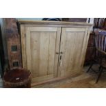 A mid 19th Century pine two door cupboard with sectional interior