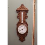 A late 19th Century oak cased aneroid barometer,
