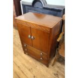 A mid 20th Century oak two door two drawer cupboard