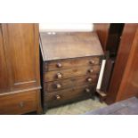 An early Victorian mahogany four drawer bureau on splayed feet (interior as found)