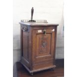 An Edwardian oak coal cabinet with brass gallery top and carrying handles,
