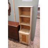 A vintage pine narrow shelved cupboard