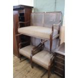 An early 20th Century upholstered mahogany bergere suite of two chairs and a double sofa