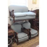 A 1920's mahogany upholstered bergere two seater settee together with two armchairs