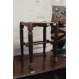 A late 19th Century oak country stool with rush seat