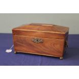 An early 19th Century mahogany and boxwood line inlaid tea caddy, of sarcophagus form,