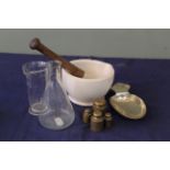 A mixed lot comprising mortar and pestle, measuring spoon, various brass weights,