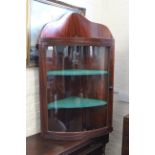 A George III mahogany bow fronted glazed corner cabinet with reeded mouldings