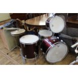 A vintage cherry red drum kit with cymbals