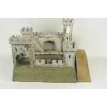 A hand painted wooden fort set with metal gun turrets,