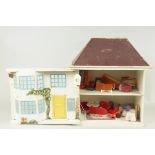 A vintage small dolls house, wood constructed with tin plate sliding front,