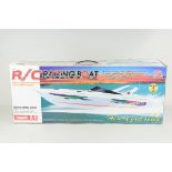 A boxed radio controlled racing boat,