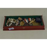 A small box of miscellaneous items of interest including medallions, dress brooches,