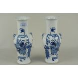 A pair of blue and white Chinese vases decorated with female figures in a tea garden (minor rim and