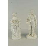 A late 19th Century Parian figure of a young woman holding bunches of grapes and a young man