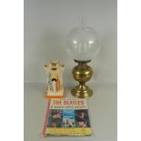 A brass oil lamp with glass shade,