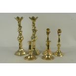 Two pairs of brass candlesticks, one pair with dragons coiled around the top,