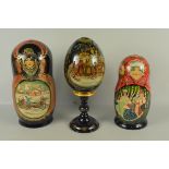 Two turned wood sets of Russian dolls decorated with a Troika scene and ladies in traditional