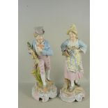 A large pair of early 20th Century continental Dresden style porcelain figurines with crossed