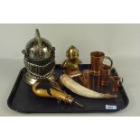 A mixed lot of handmade copper and brass items including powder flasks, knights helmets,