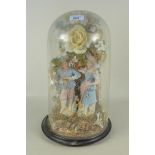 A continental porcelain display of two figures with ceramic flowers under a glass dome,