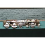 A collection of nine teapots including a silver lustre example with sugar bowl and cream jug plus a