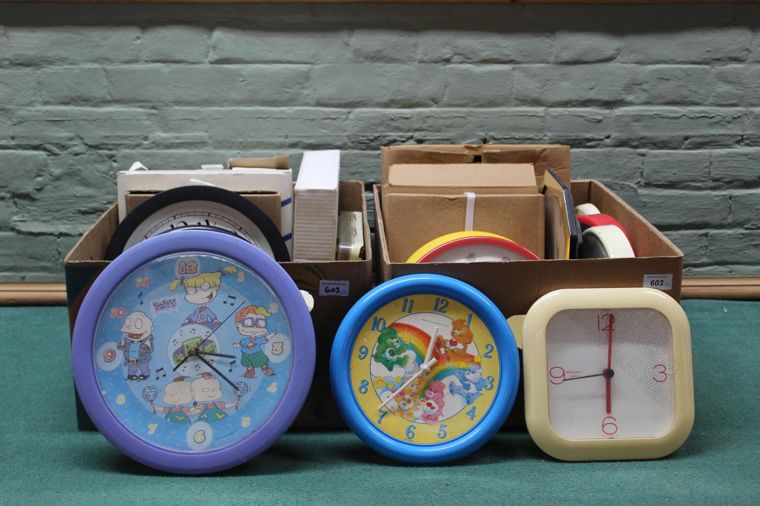 Two boxes of approx twenty four wall clocks,