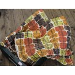 A pair of vintage fabric curtains in orange, yellow and brown pattern,