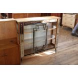 A c.1950's glazed drinks cabinet with veneered top and decorated glass doors