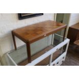 A vintage teak coffee table with marquetry style top