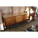 A mid Century teak sideboard, with tri-sliding doors,