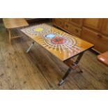 An unusual design tile topped coffee table with chrome legs and teak supports