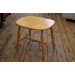 A blonde beech stool with tapered stretcher base