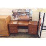 A mid Century teak dressing table with tri-fold mirror and seven drawers