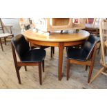 A mid Century blonde and dark teak extending dining table plus four teak dining chairs by Elliots