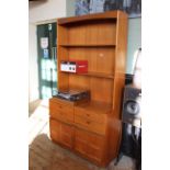 A c.1970's teak free standing shelving unit with four drawers and two cupboards
