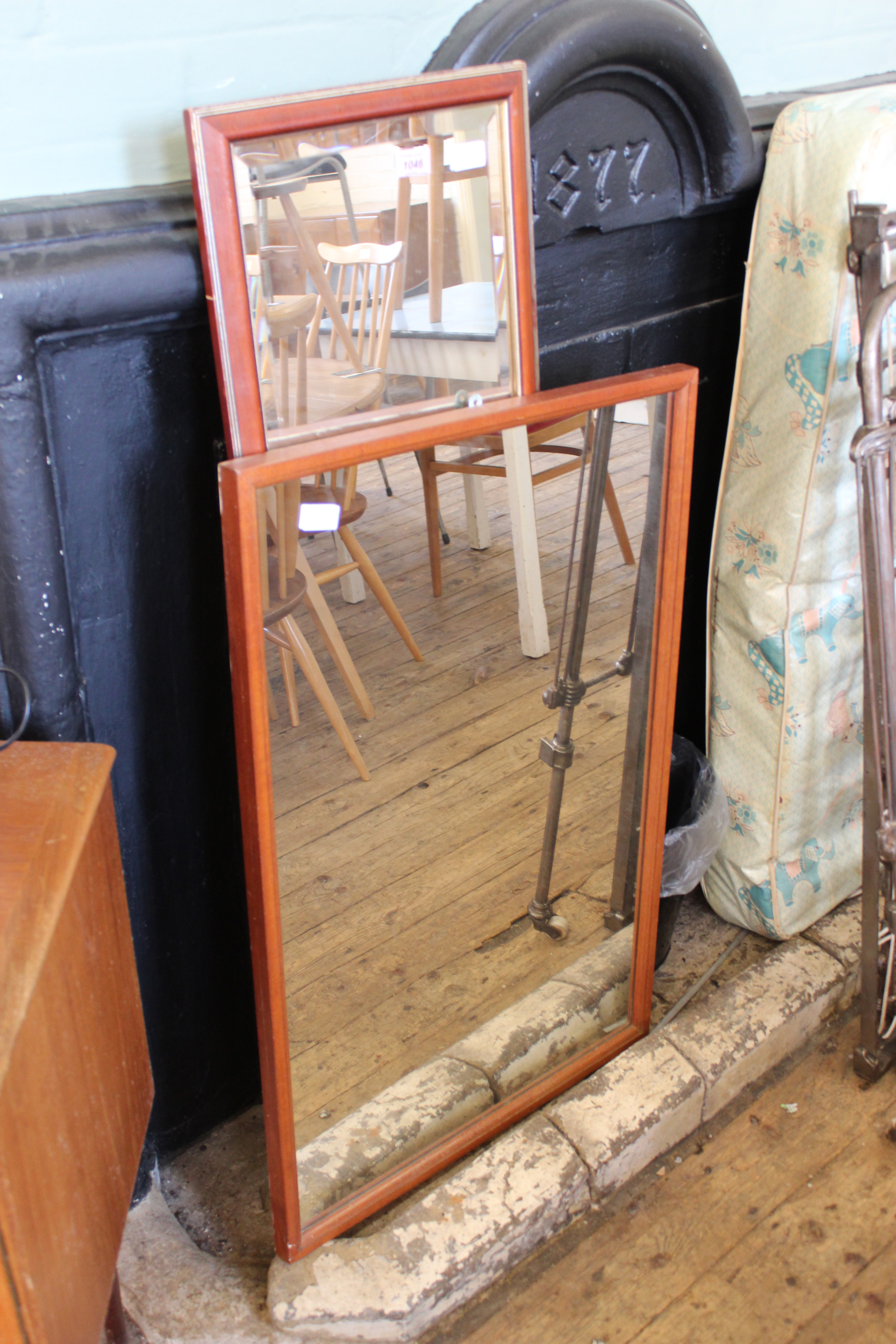 A rectangular teak framed wall mirror and one other